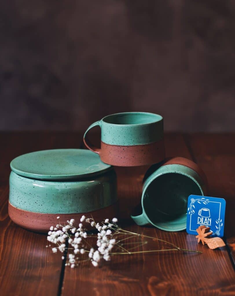 a couple of cups sitting on top of a wooden table